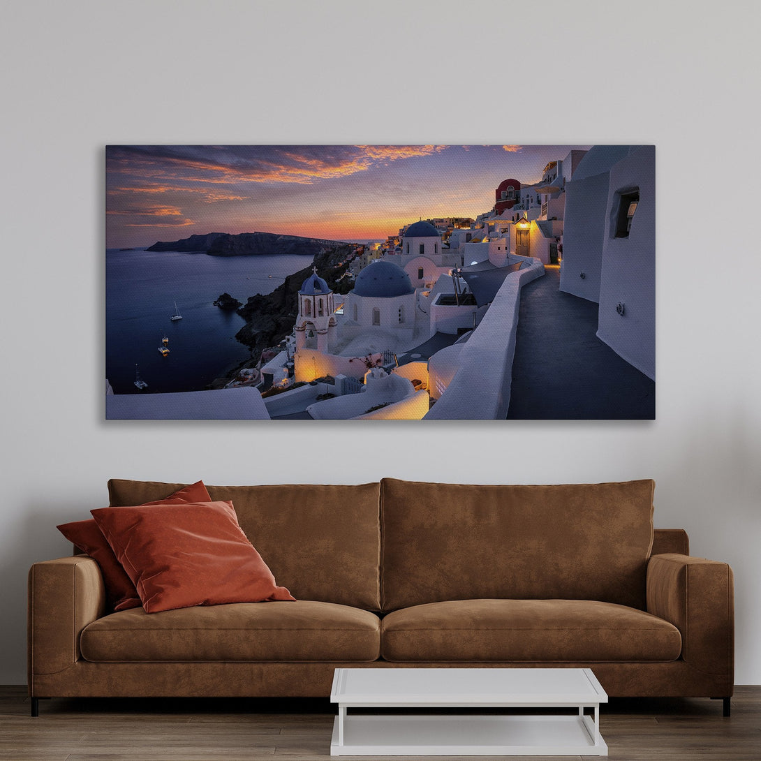Framed Wall Art featuring Santorini sunset. Coastal scene with white buildings, blue domes, and a warm color palette. Perfect for home decor.