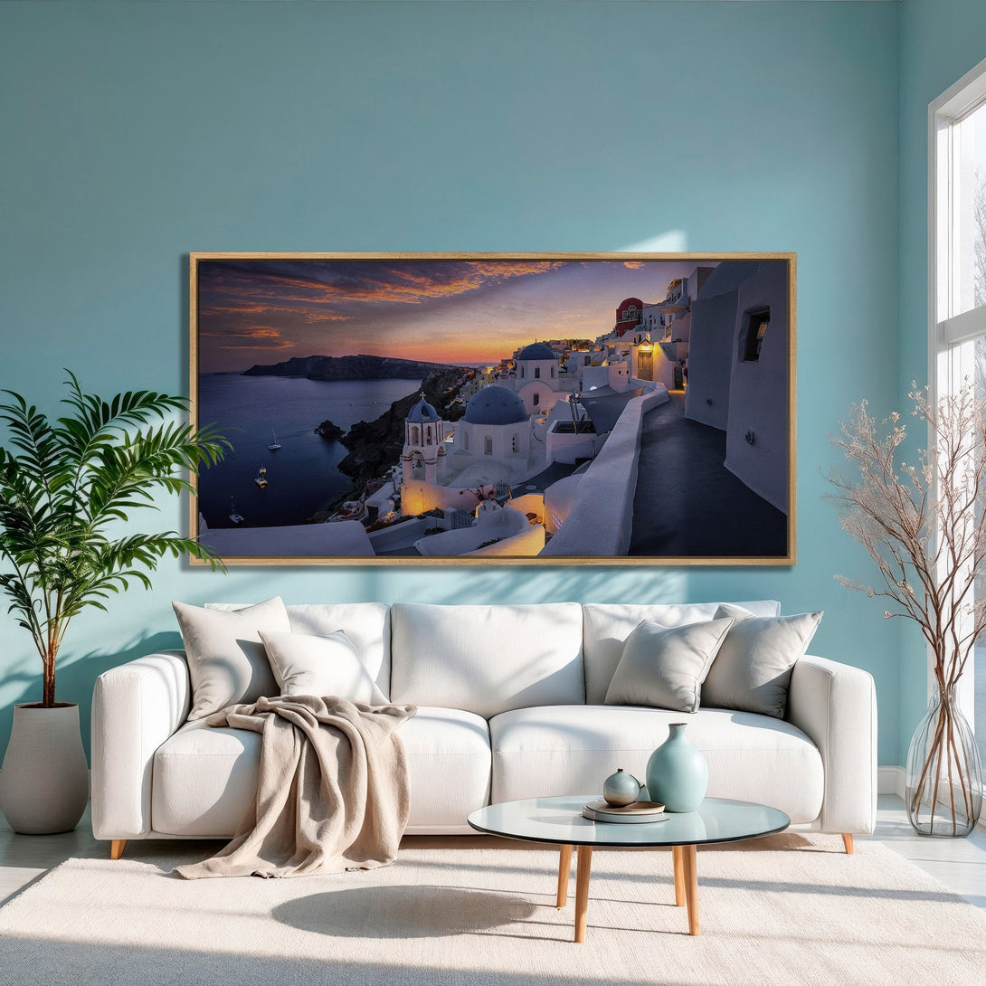 Framed Wall Art of Santorini sunset. Mediterranean style Canvas Print with blue, white, and warm sunset hues. Perfect for living room decor.