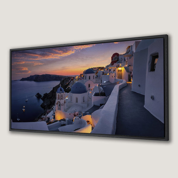 Framed Wall Art: Santorini sunset Canvas Print. Stunning coastal landscape with white buildings, blue domes, and warm sunset hues. Perfect travel decor!