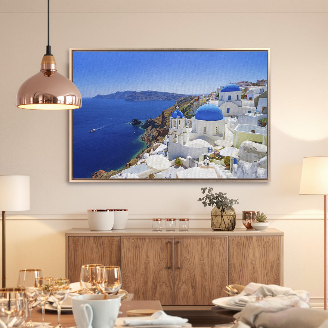 Framed Wall Art of Santorini, Greece. Blue & white buildings against a vibrant blue sky. Coastal landscape art for home decor.
