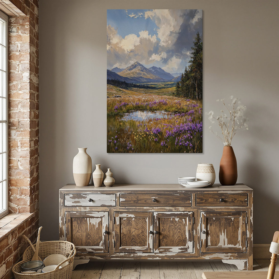 Framed Wall Art: Landscape painting of mountains and wildflowers. Earthy tones and vibrant purples create a serene atmosphere. Perfect for dining room decor.