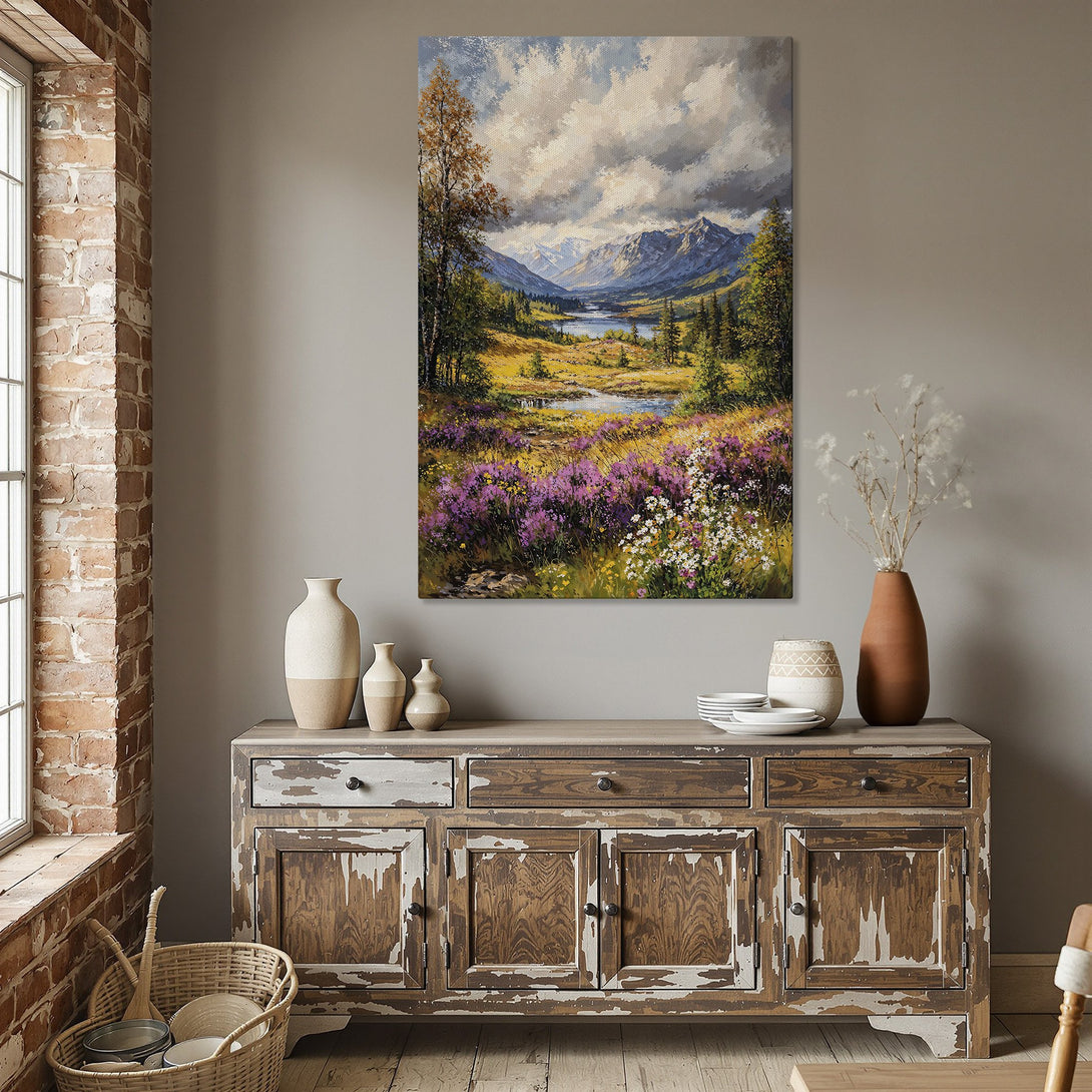Framed Wall Art: Landscape painting with mountains, river, and colorful wildflowers. Earthy tones and gold frame create a warm, inviting atmosphere. Perfect home decor!