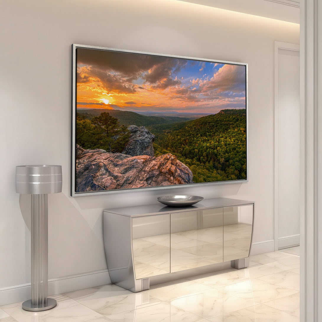 Framed Wall Art featuring a stunning sunset landscape. Warm orange, yellow, and blue hues create a vibrant, natural scene. Perfect for adding a touch of nature to your home.