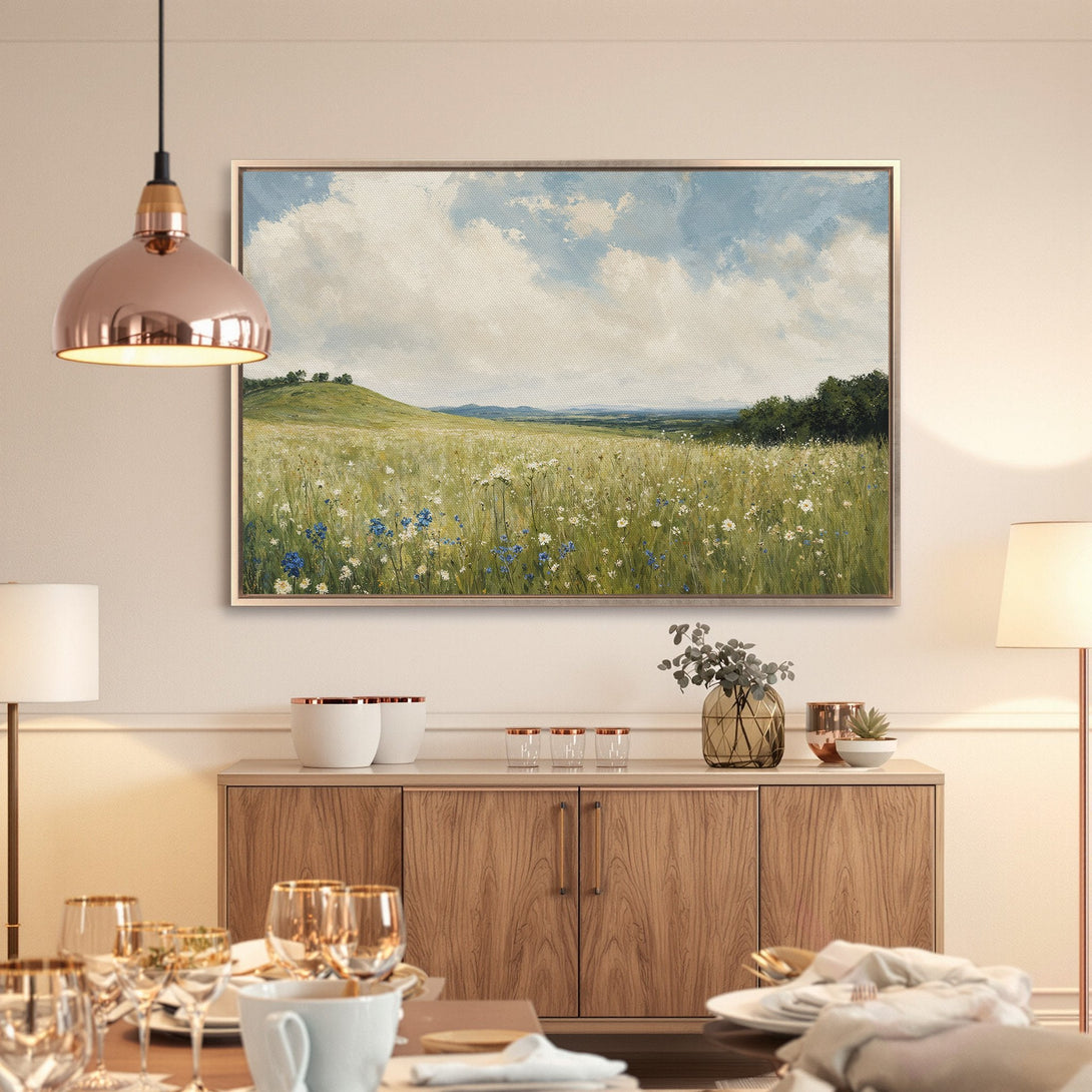 Framed Wall Art: Landscape Canvas Print in a dining room. Features a field of wildflowers, blue sky, and a warm, neutral color palette.