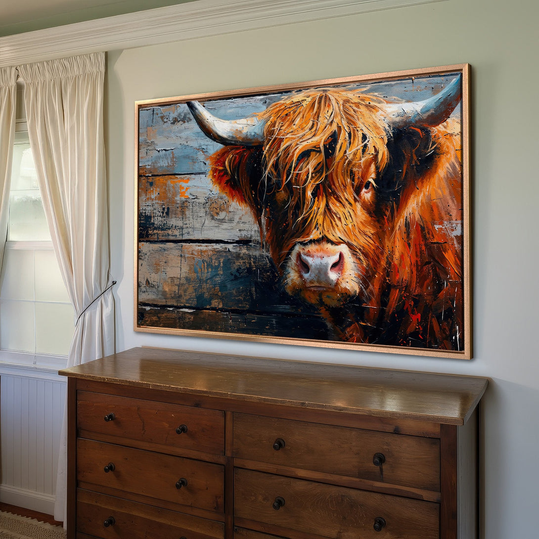 Framed Wall Art: Highland cow portrait in warm orange and blue tones. Rustic style Canvas Print adds a touch of farmhouse charm to your home.