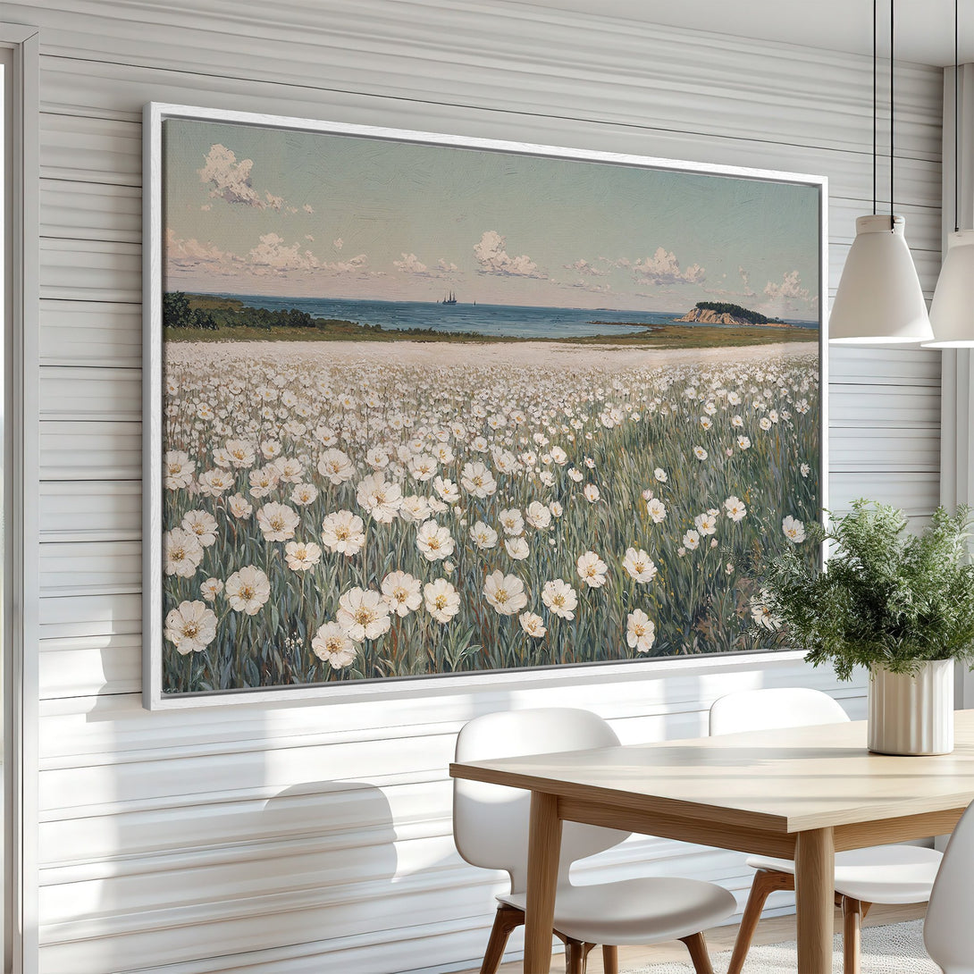 Framed Wall Art featuring a serene field of white flowers by the sea. Soft, pastel color palette adds a touch of calm to any interior.