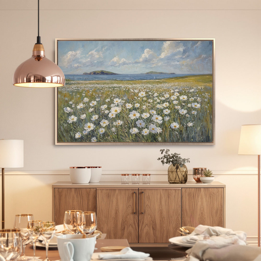 Framed Wall Art: Coastal landscape Canvas Print with white flowers, blue sky, and green fields. Serene art in a neutral color palette.