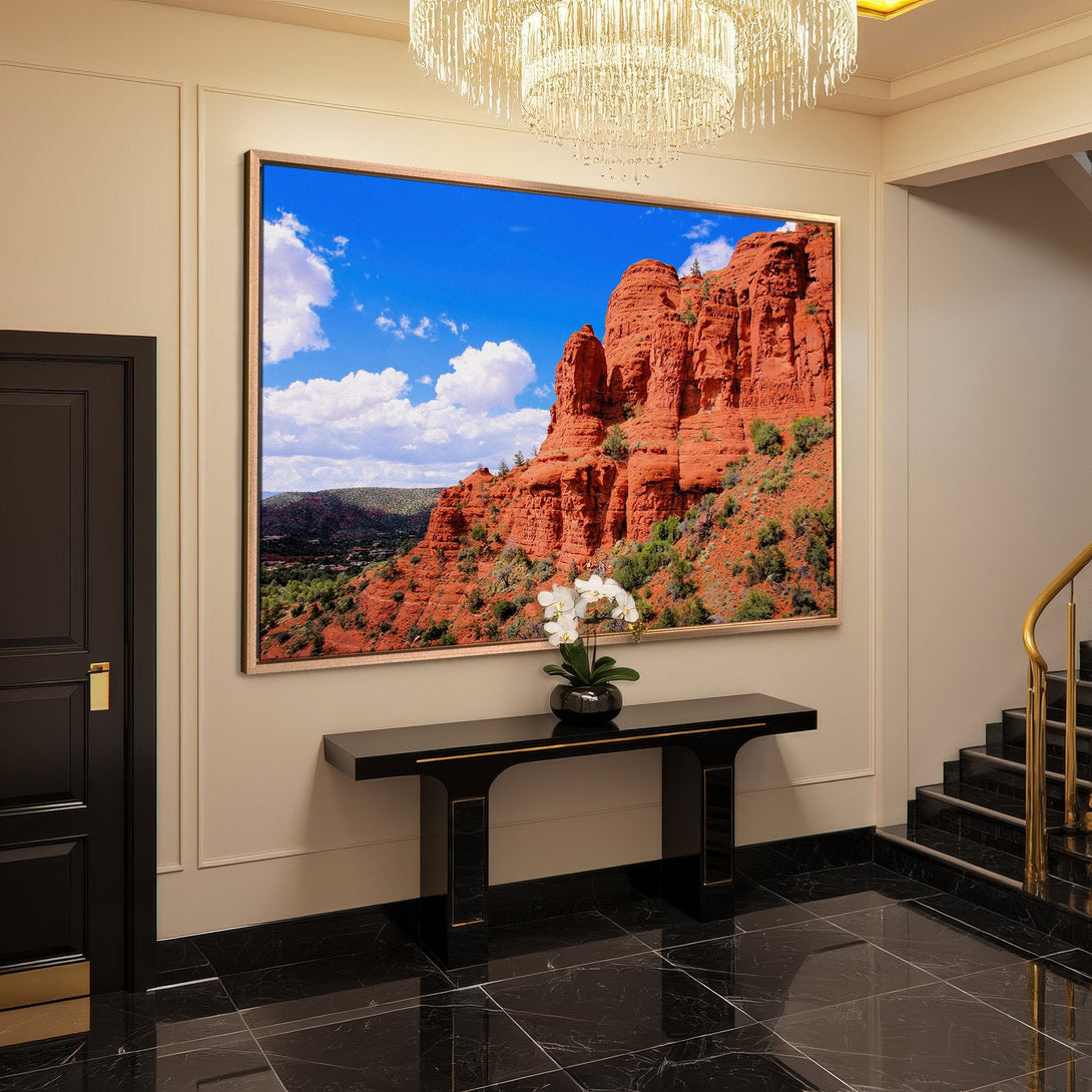 Framed Wall Art: Desert landscape Canvas Print with red rock formations and blue sky. Earthy tones add warmth to any interior.