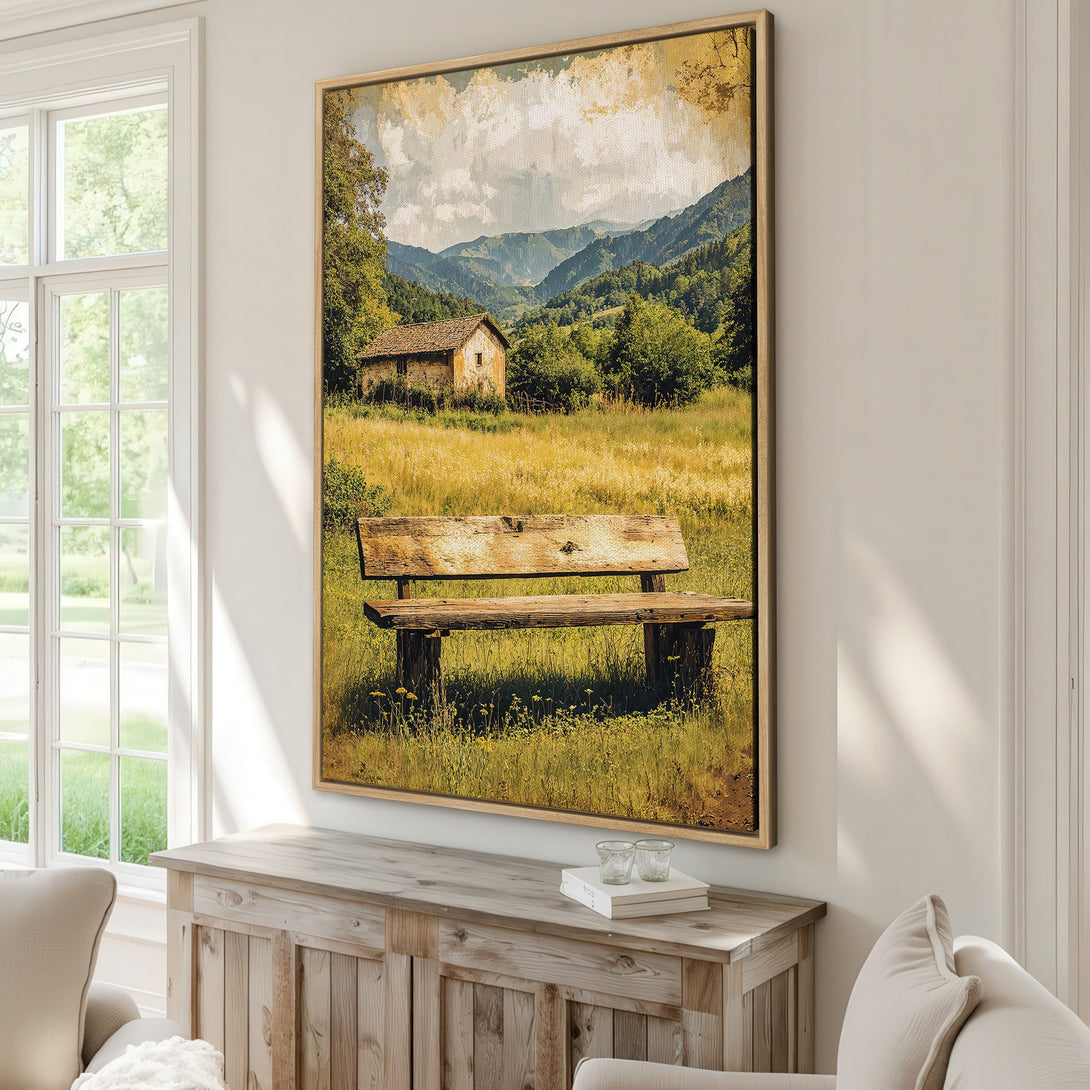 Framed Wall Art: Landscape canvas print with a rustic bench, cabin, and mountains. Warm, earthy tones of green, yellow, and brown create a serene ambiance.