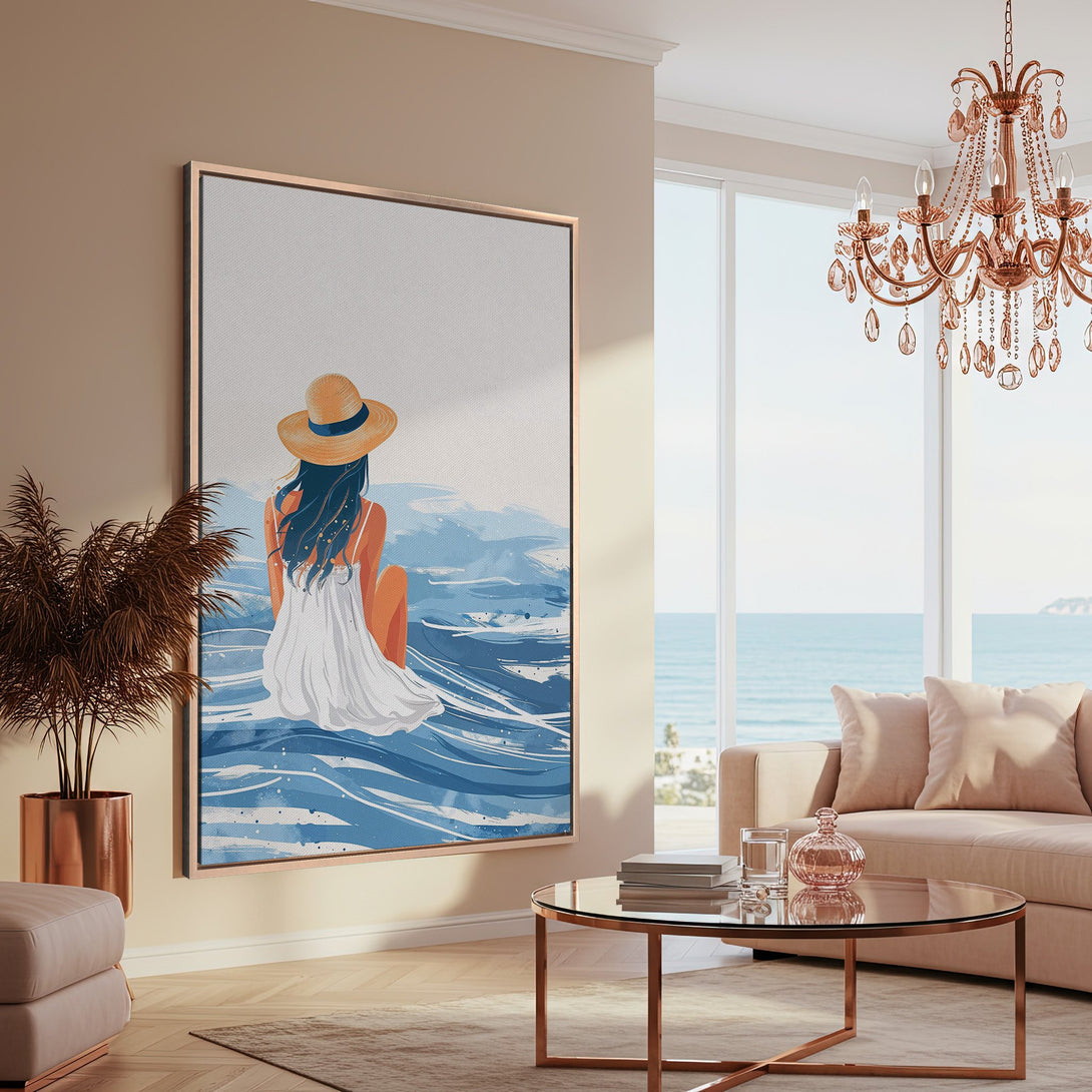 Framed Wall Art: Coastal scene Canvas Print with a woman in a white dress, blue and beige tones, displayed in a modern, light-filled interior.