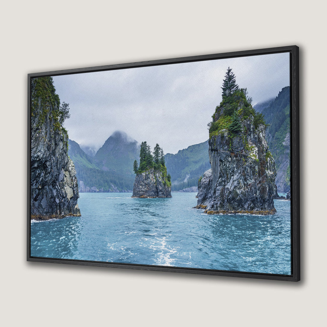 Framed Wall Art: Stunning coastal landscape Canvas Print featuring rocky islands in teal waters. Serene, moody art with green, gray, and blue hues. Bring nature indoors!