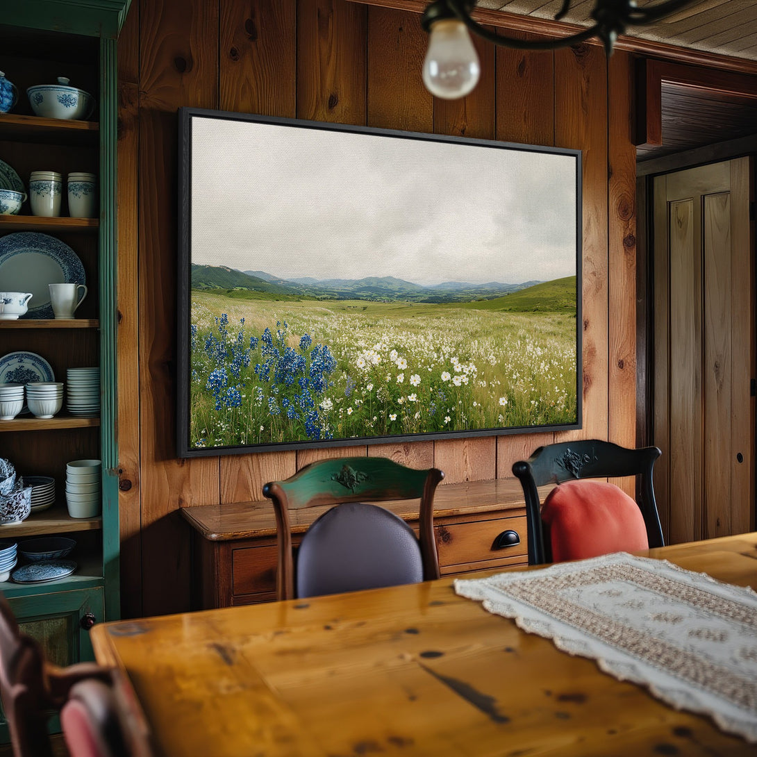 Framed Wall Art: Landscape Canvas Print featuring wildflowers and mountains in a rustic interior. Earthy tones with pops of blue and green.