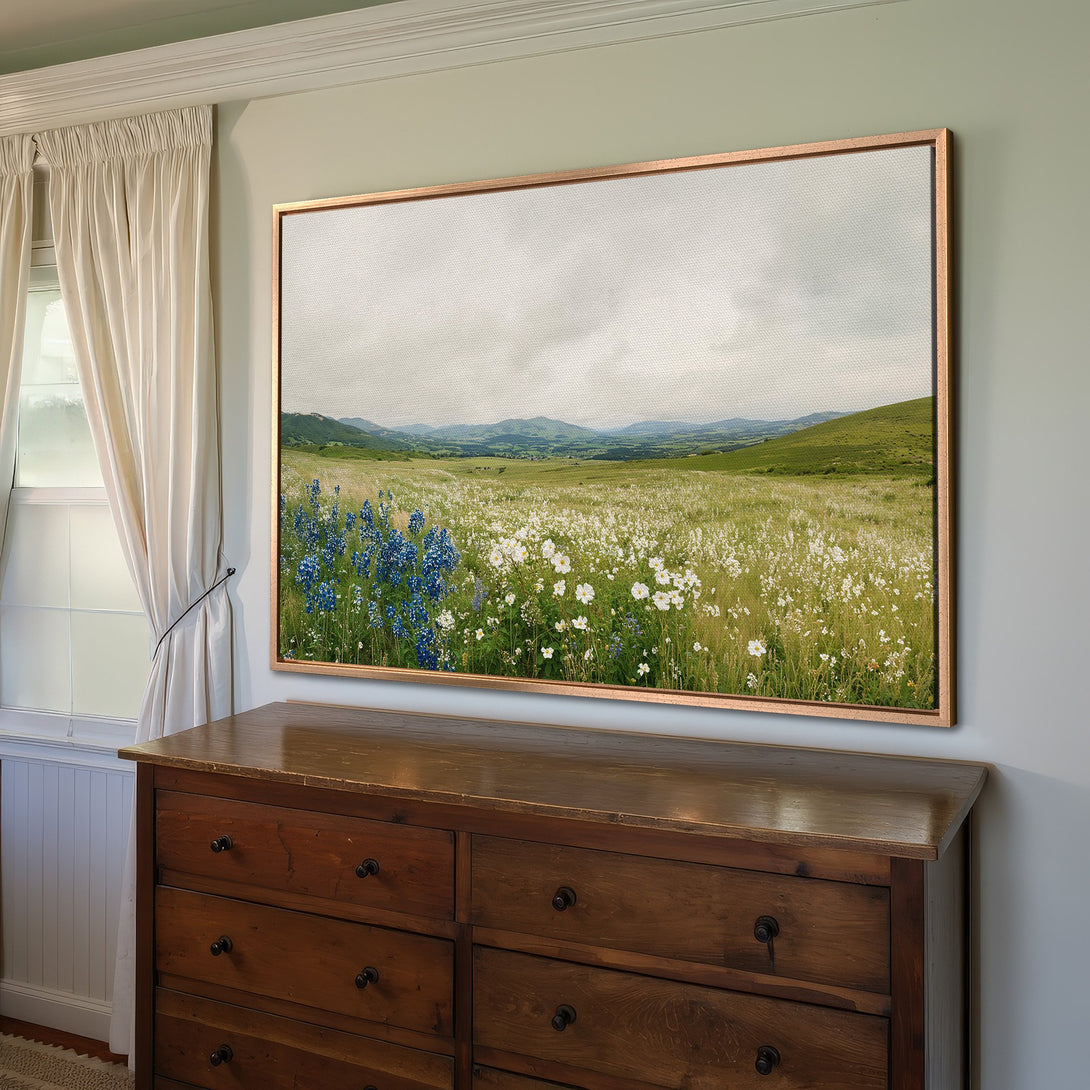 Framed Wall Art of a wildflower meadow. Neutral color palette with pops of blue and green. Perfect for adding a touch of nature to your home.