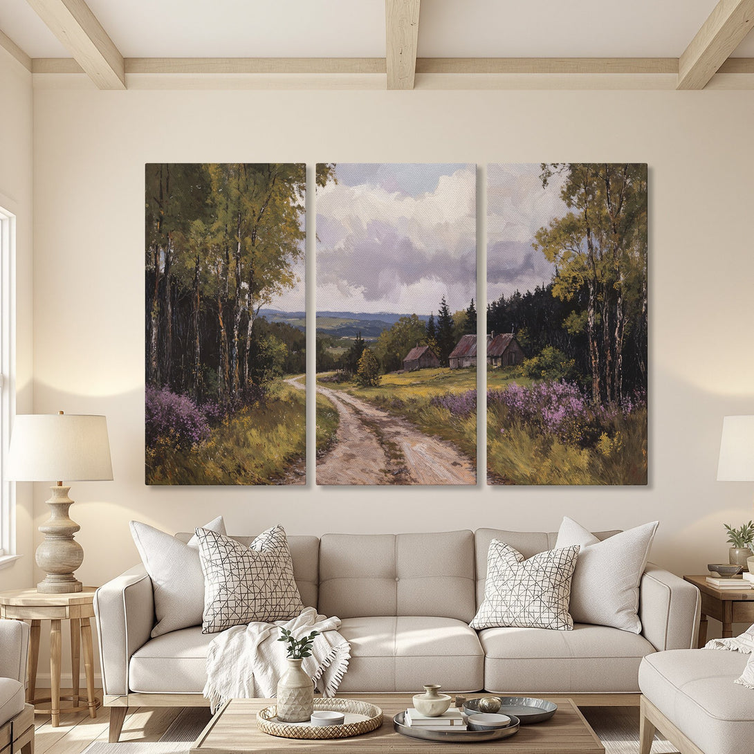 Canvas Print triptych of a serene landscape painting in a living room. Features a dirt road, trees, and houses with a muted green and purple palette.