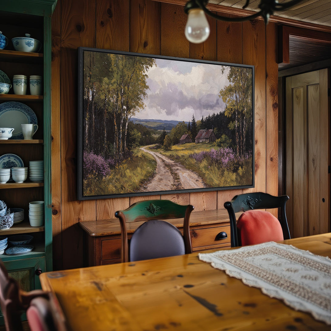 Framed Wall Art: Landscape painting with a dirt road, trees, and a cabin. Earthy tones of green, brown, and purple create a rustic, inviting atmosphere.