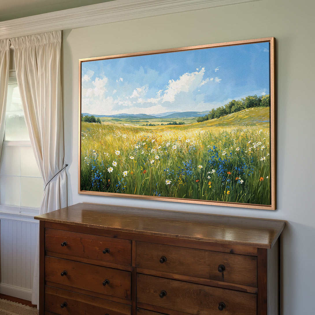 Framed Wall Art: Landscape Canvas Print featuring a vibrant field of wildflowers under a blue sky. Warm, inviting color palette perfect for any room.