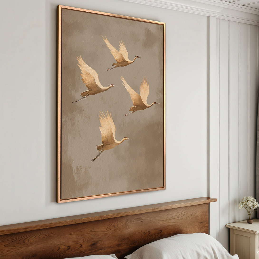 Framed Wall Art featuring elegant cranes in flight. Neutral color palette with gold frame. Perfect for adding a touch of nature-inspired art to your home.