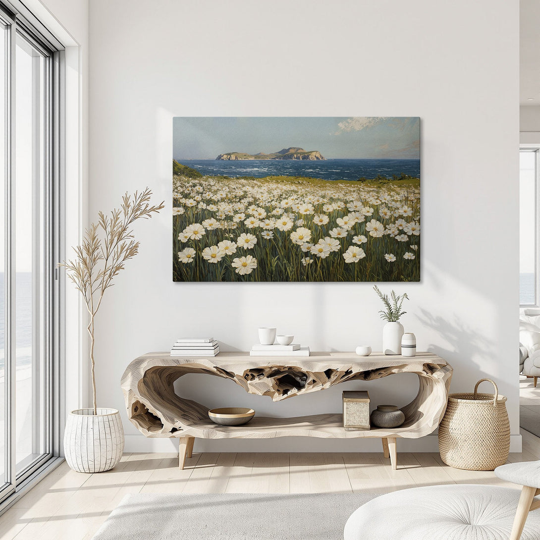 Framed Wall Art: Coastal landscape Canvas Print with white flowers, blue ocean, and gold frame. Serene, natural color palette for a calming interior.