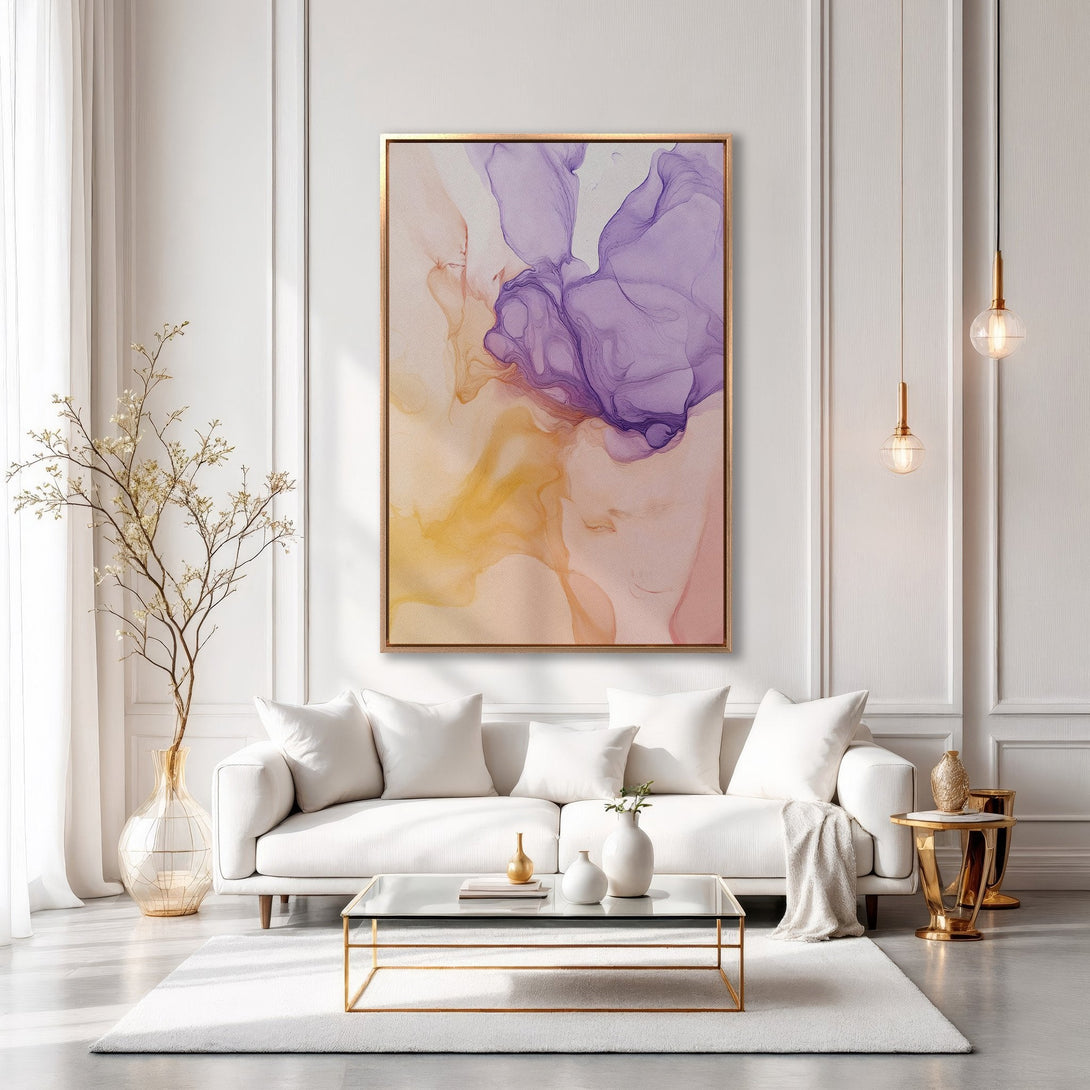 Framed Wall Art: Abstract fluid art Canvas Print in purple, yellow, and peach tones. Modern interior design with a white sofa, gold accents, and a luxurious feel.