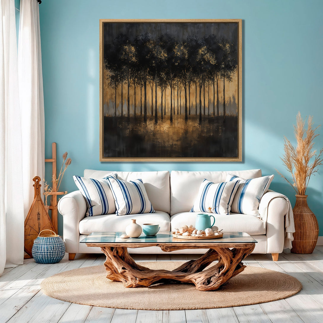 Framed Wall Art of black trees with gold accents in a modern living room. Earthy tones and blue wall create a calming atmosphere.