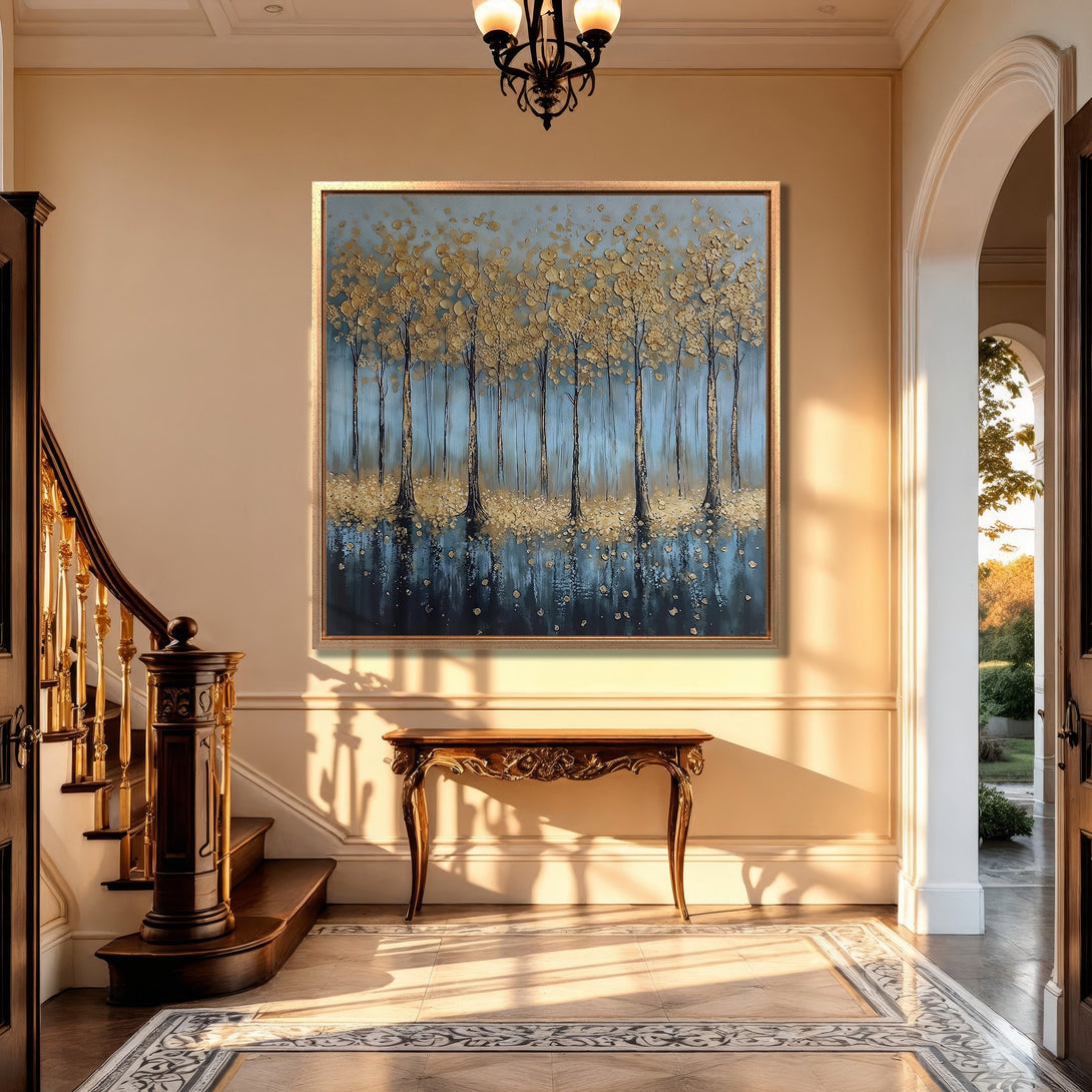 Framed Wall Art: Abstract gold trees on blue canvas, displayed in a luxurious entryway. Warm, inviting color palette. Elevate your home decor!