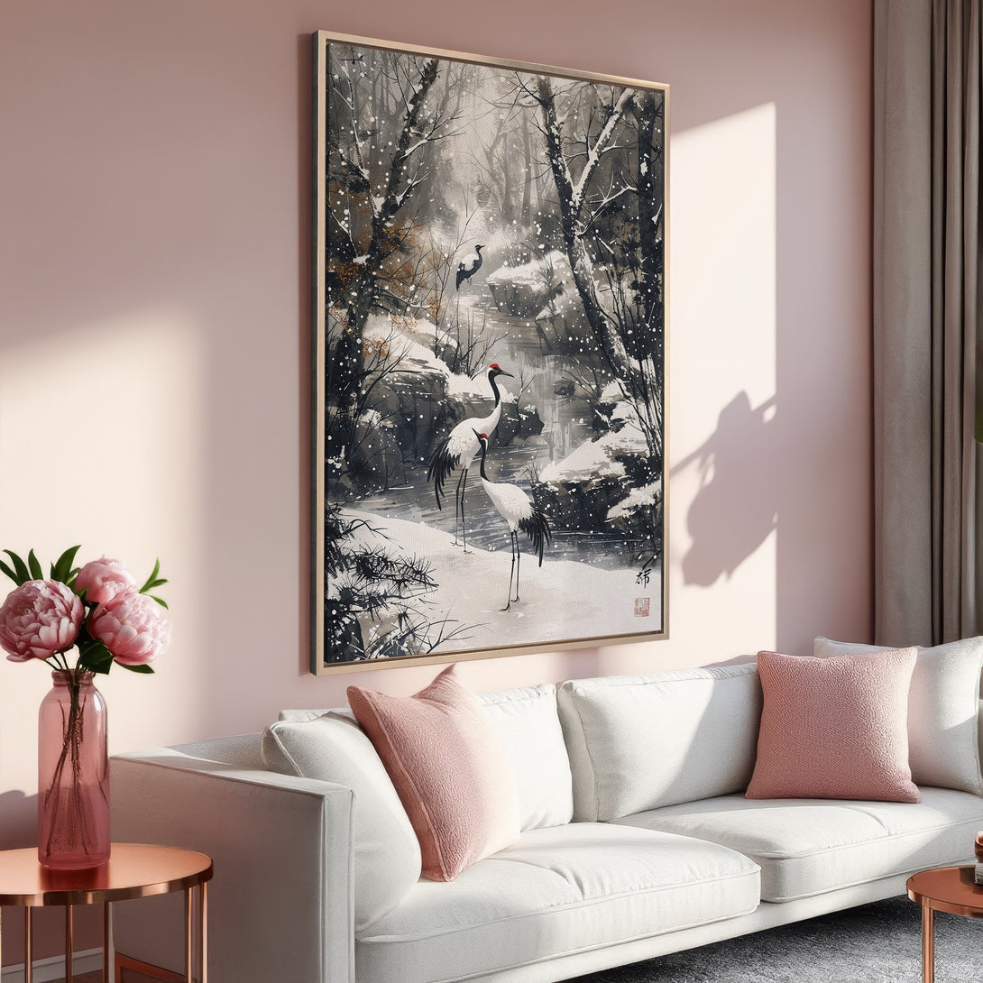 Framed Wall Art: Japanese crane painting in a snowy forest, neutral tones with pops of red, displayed in a modern living room.