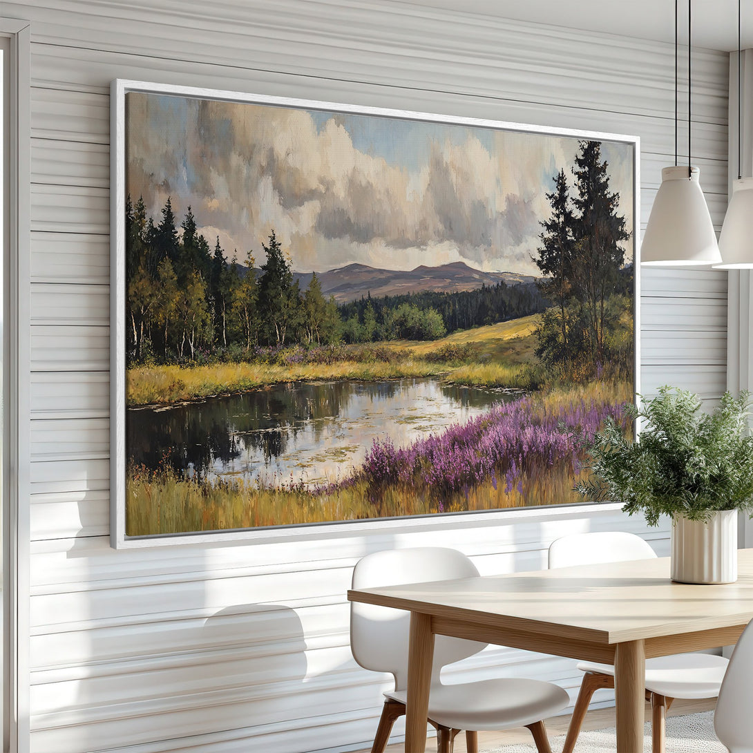 Framed Wall Art: Landscape painting in a dining room. Featuring a serene lake scene with trees, purple flowers, and a muted color palette. Enhance your space!