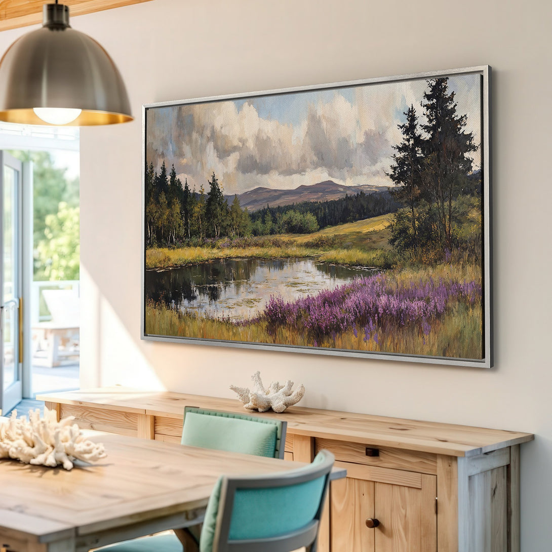 Framed Wall Art featuring a landscape painting with a pond, trees, and purple flowers. Earthy tones create a serene atmosphere for your home decor.