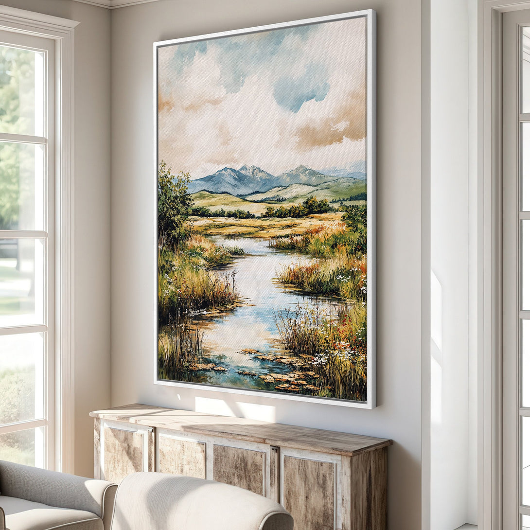 Framed Wall Art: Watercolor landscape Canvas Print in a neutral interior. Features a river scene with mountains, soft blues, greens, and warm earth tones.