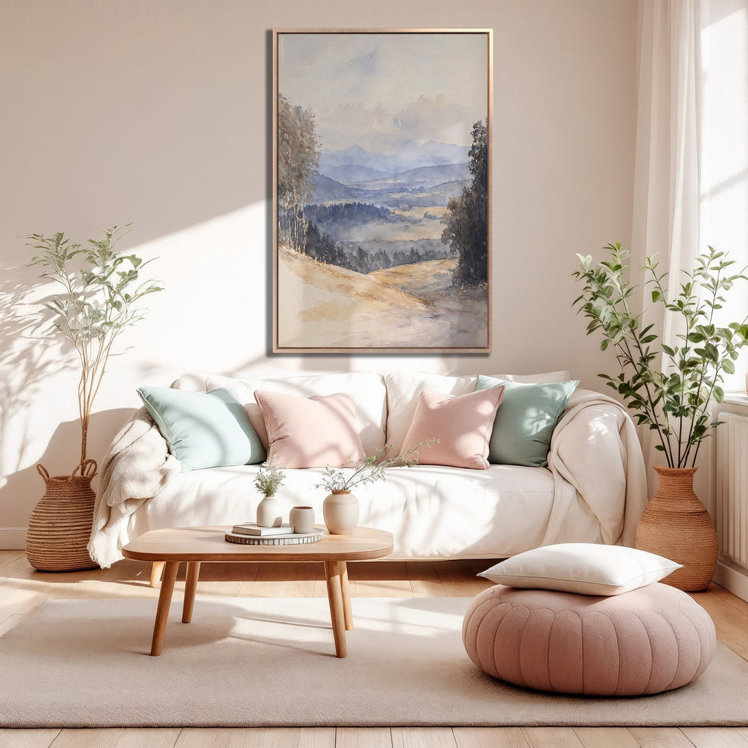 Framed Wall Art: Watercolor landscape print in a warm, neutral interior. Features a serene mountain scene with blue, beige, and gray tones. Perfect for adding a touch of calm.