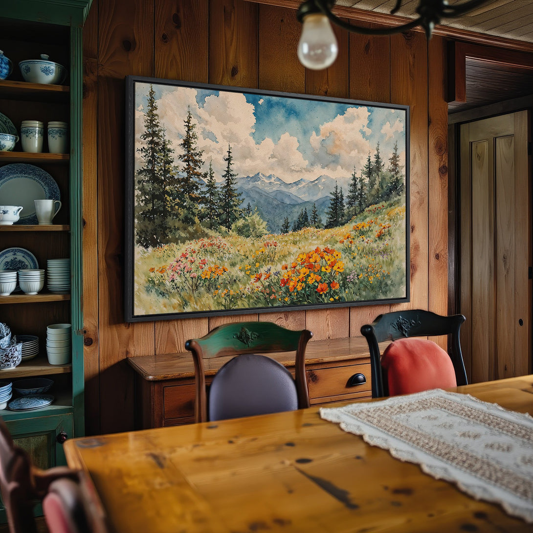 Framed Wall Art: Watercolor landscape Canvas Print with mountains, trees, and wildflowers. Earthy tones of blue, green, and orange create a serene aesthetic.