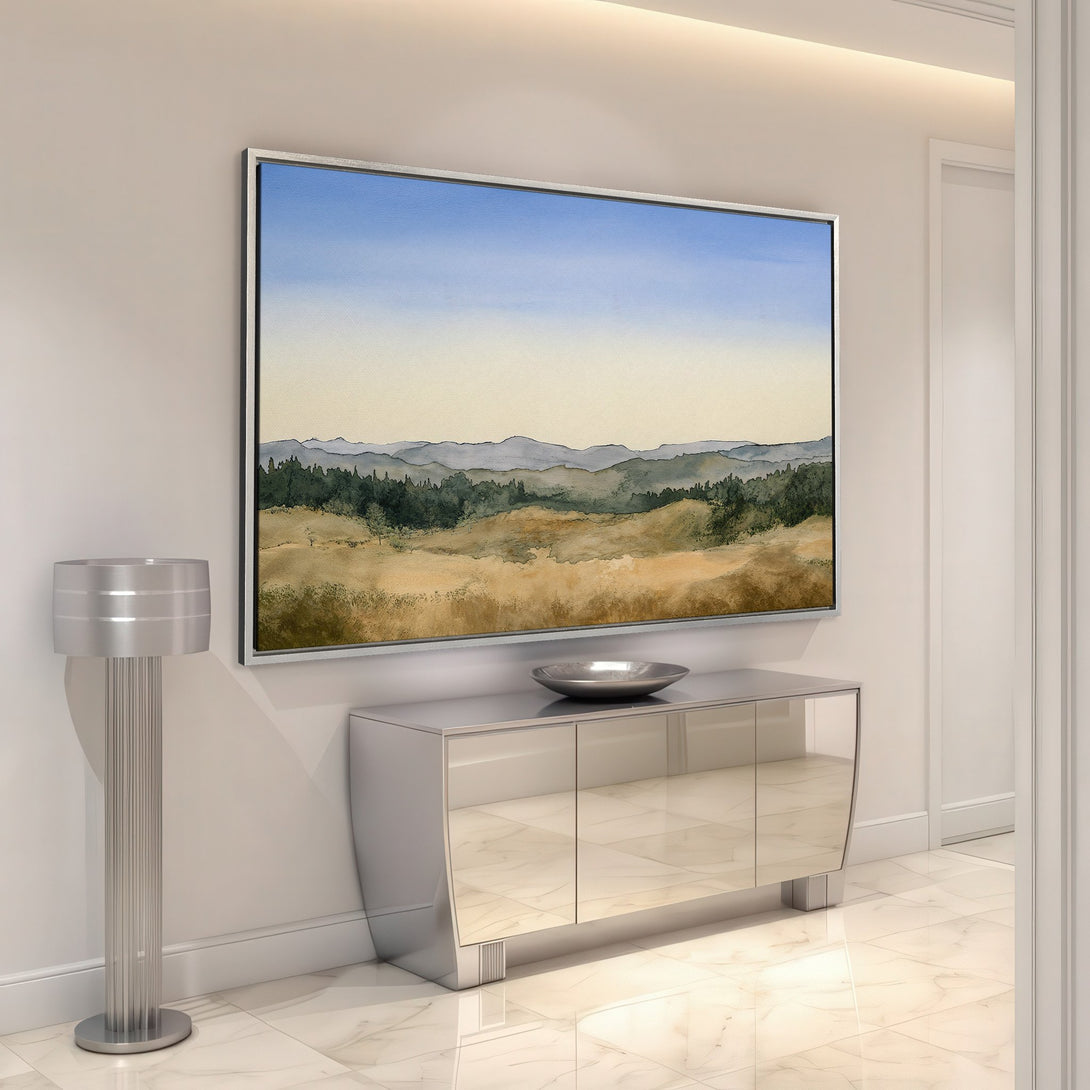 Framed Wall Art featuring a watercolor landscape in warm earth tones and blue sky. Elevate your home decor with this stunning Canvas Print.