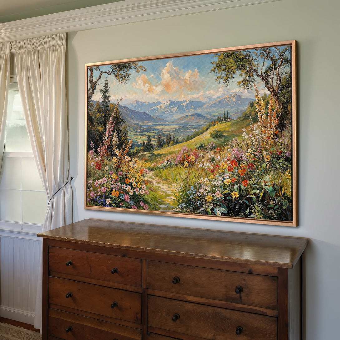 Framed Wall Art featuring a vibrant landscape painting with a colorful floral foreground and mountain backdrop. Warm, inviting color palette.