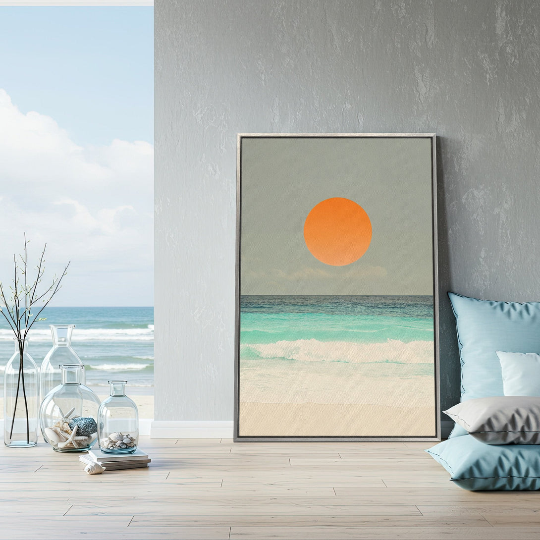 Framed Wall Art: Coastal sunset Canvas Print in a serene interior. Featuring orange sun, teal ocean, and neutral tones. Perfect for modern home decor.