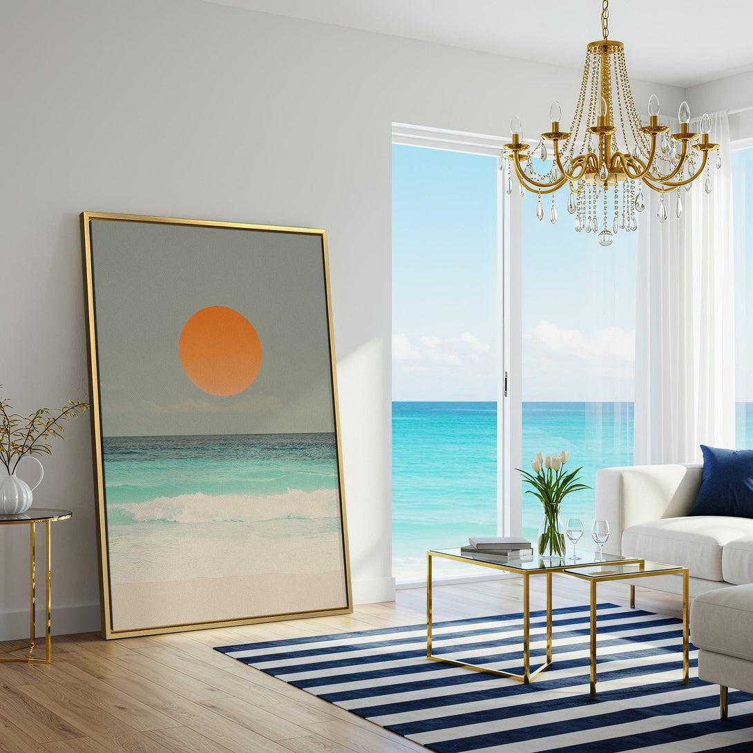 Canvas Print of a beach scene with an orange sun, displayed in a bright living room. Coastal style art with blue, orange, and neutral tones.