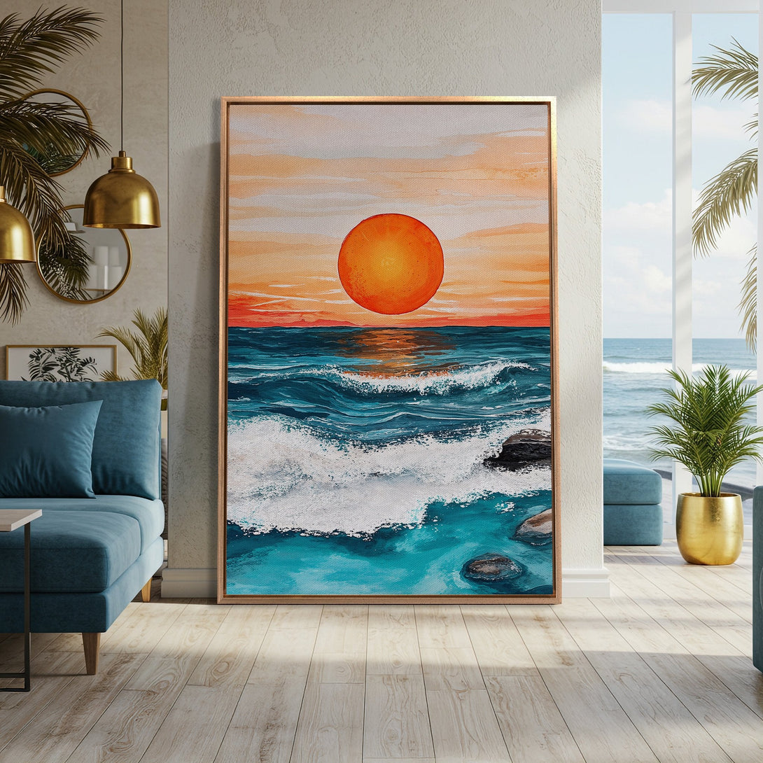 Framed Wall Art: Sunset over ocean canvas print in a modern interior. Coastal artwork with blues, oranges, and whites. Bring the beach home!