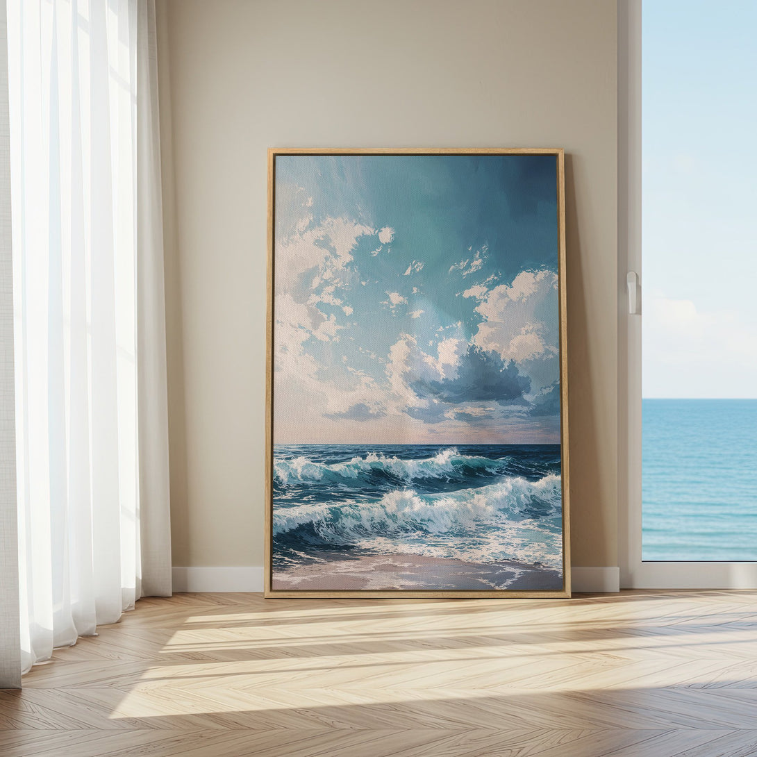 Framed Wall Art of ocean waves in a serene blue and white color palette, displayed in a bright, airy interior setting.