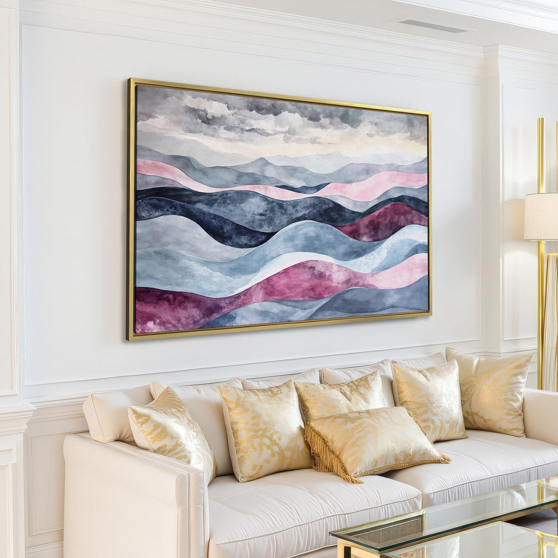 Canvas Print of abstract watercolor landscape art in a modern living room. Features a muted blue, pink, and purple color palette.