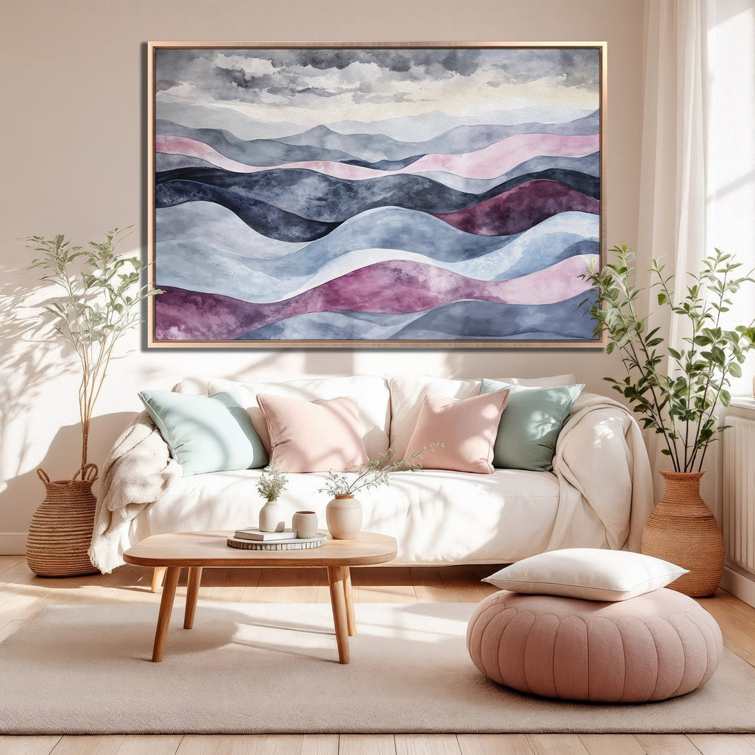 Framed Wall Art featuring an abstract watercolor landscape in a modern living room. Soft blues, pinks, and grays create a calming, artistic vibe.