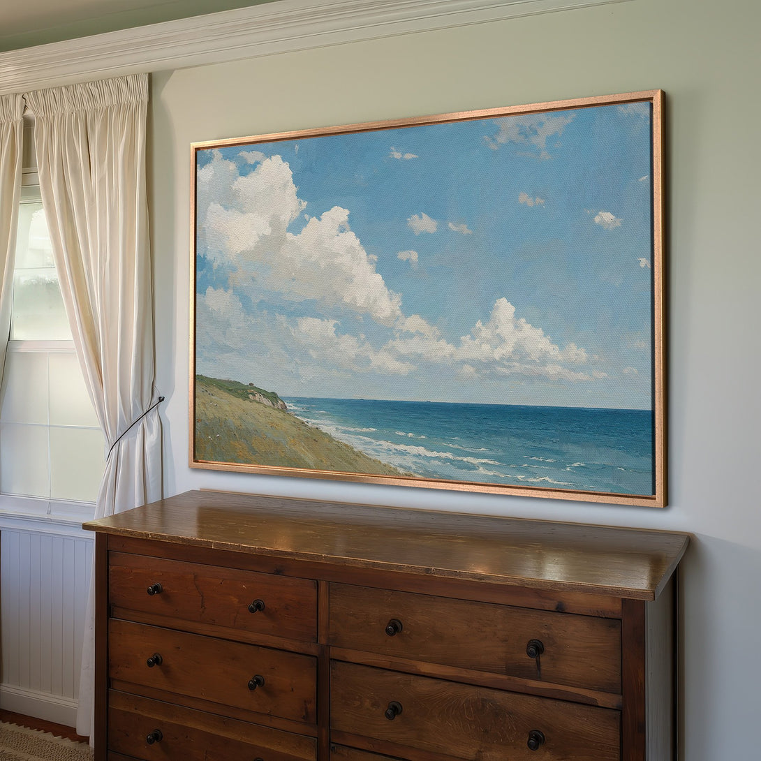 Framed Wall Art Canvas Print of a seascape with blue sky, white clouds, and ocean. Coastal art in a gold frame, perfect for home decor.