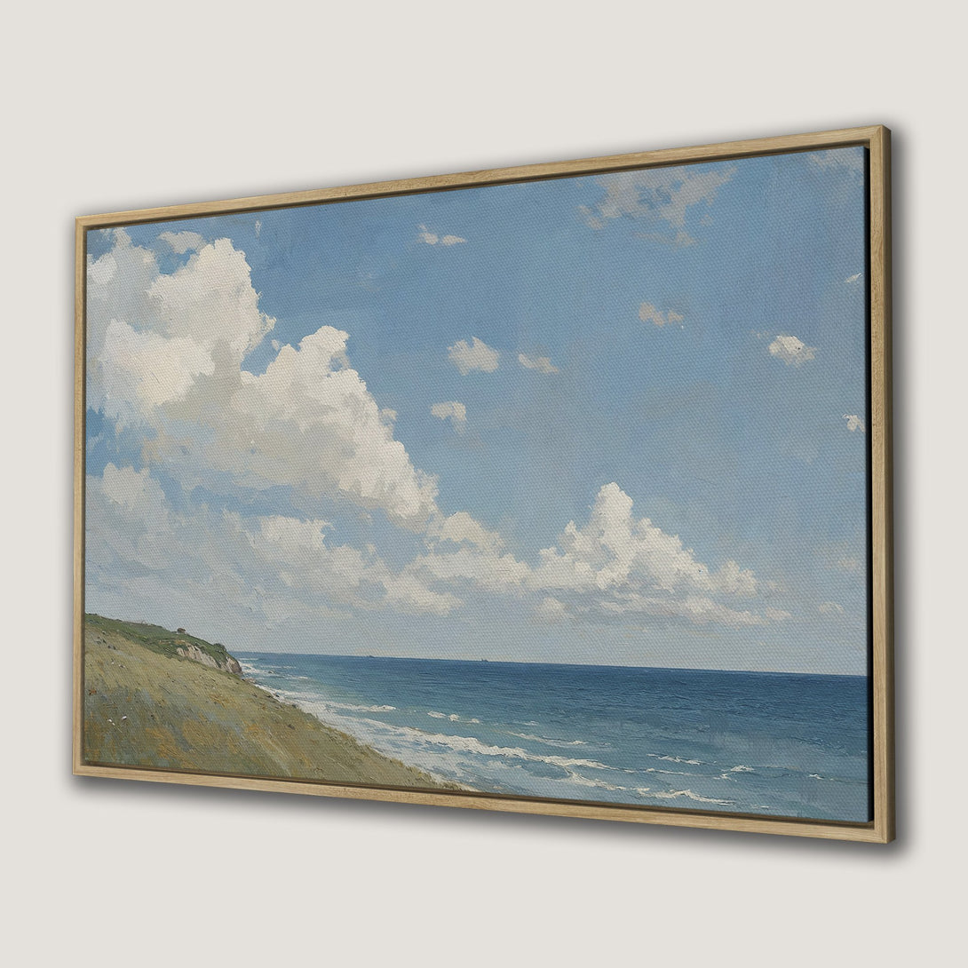 Framed Wall Art Canvas Print of a serene coastal landscape with blue sky, white clouds, and ocean in a light, airy color palette.