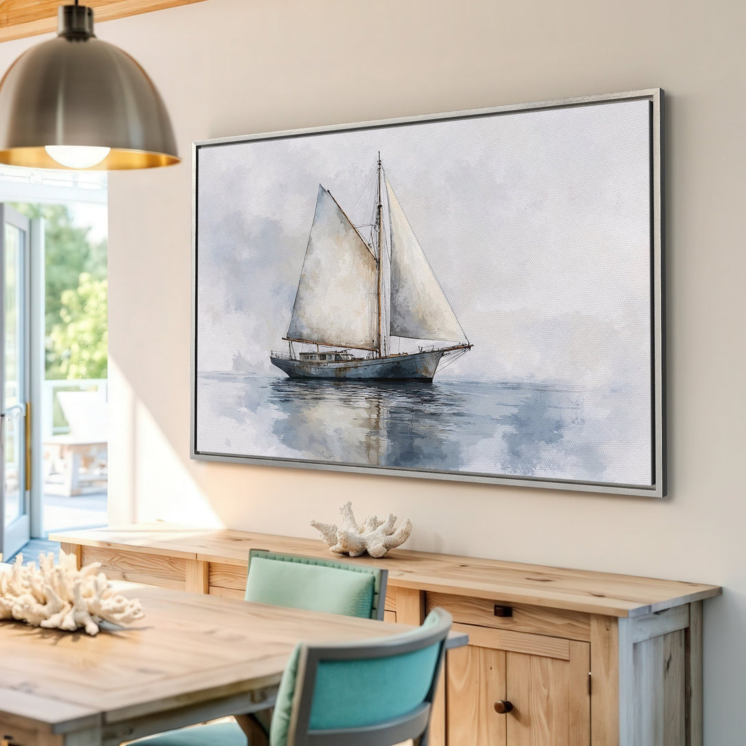 Framed Wall Art: Watercolor sailboat print in a coastal style. Serene blue and gray color palette. Perfect for adding a touch of nautical charm to your home.