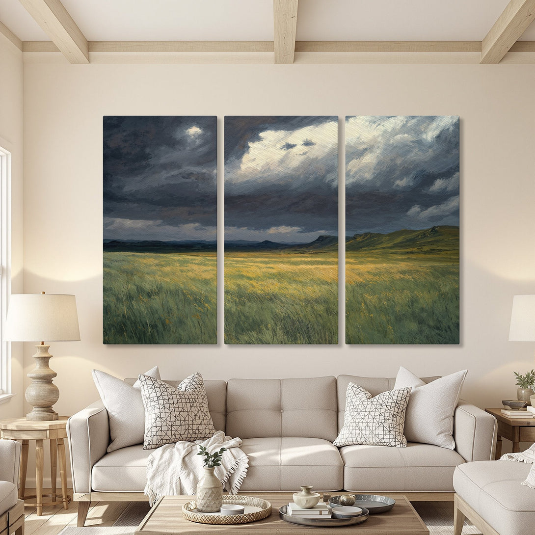Canvas Print of a dramatic landscape painting in a living room. Features a stormy sky over a field of green and gold, with a cool color palette.