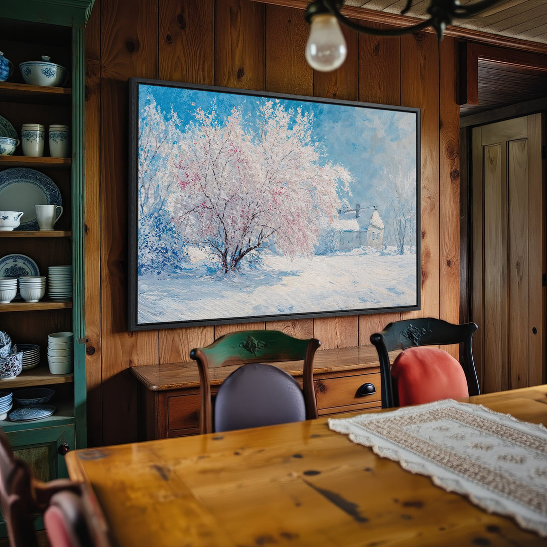 Framed Wall Art: Winter landscape Canvas Print with a snowy scene, featuring a tree with pink blossoms. Blue, white, and pink color palette.