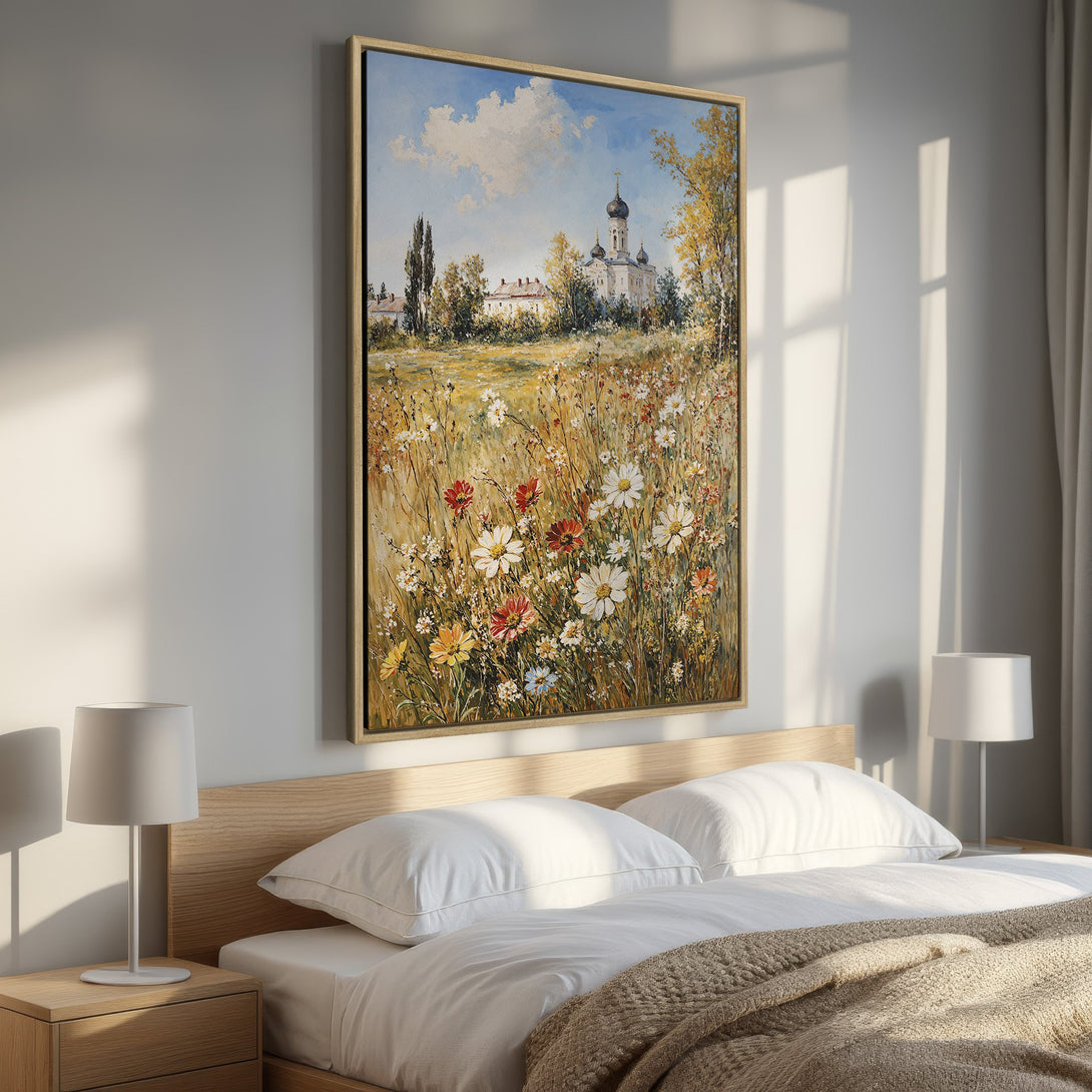 Framed Wall Art: Pastoral landscape Canvas Print with wildflowers, church, and blue sky. Warm, inviting color palette for a cozy bedroom.
