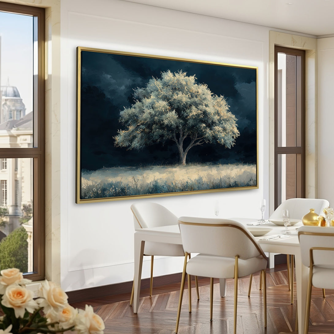 Canvas Print of a majestic tree in a moody, dark blue and white landscape, perfect for adding a touch of art to your home office.