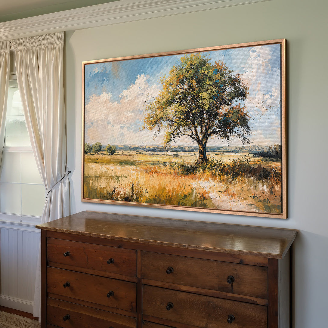 Framed Wall Art: Landscape Canvas Print with a large tree in a field, warm color palette of yellows, greens, and blues. Perfect home decor.