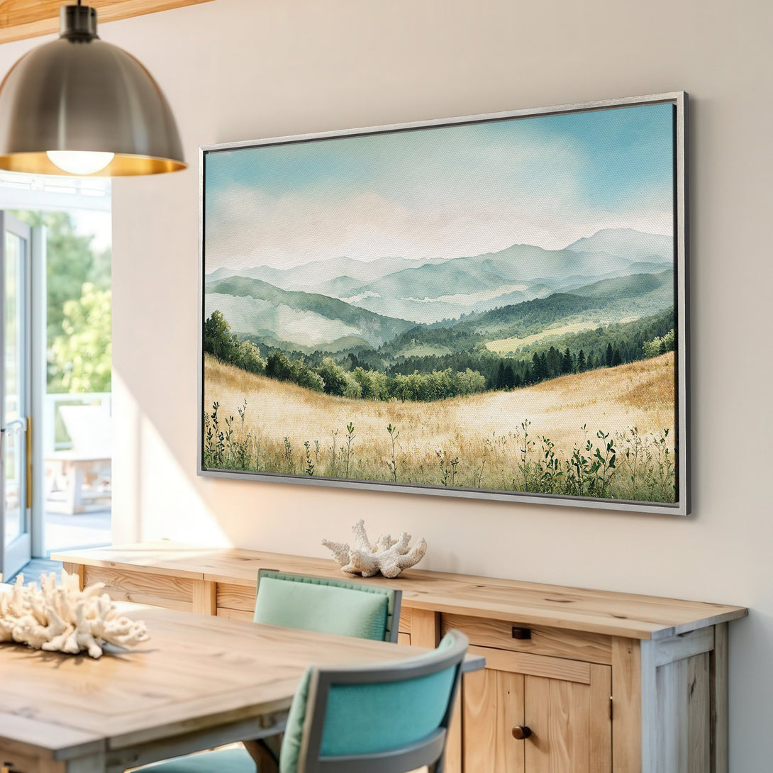 Framed Wall Art featuring a watercolor landscape with mountains and fields in a calming green and gold palette. Perfect for adding a touch of nature to your home.