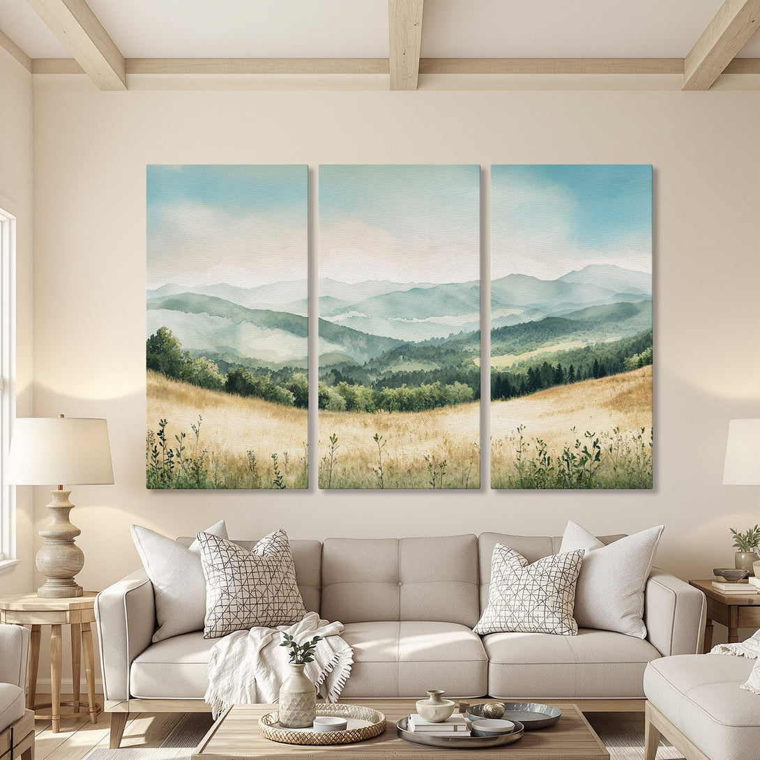 Canvas Print of a serene watercolor landscape in a living room. Features mountains, fields, and a calming blue, green, and gold palette. Perfect for any home!