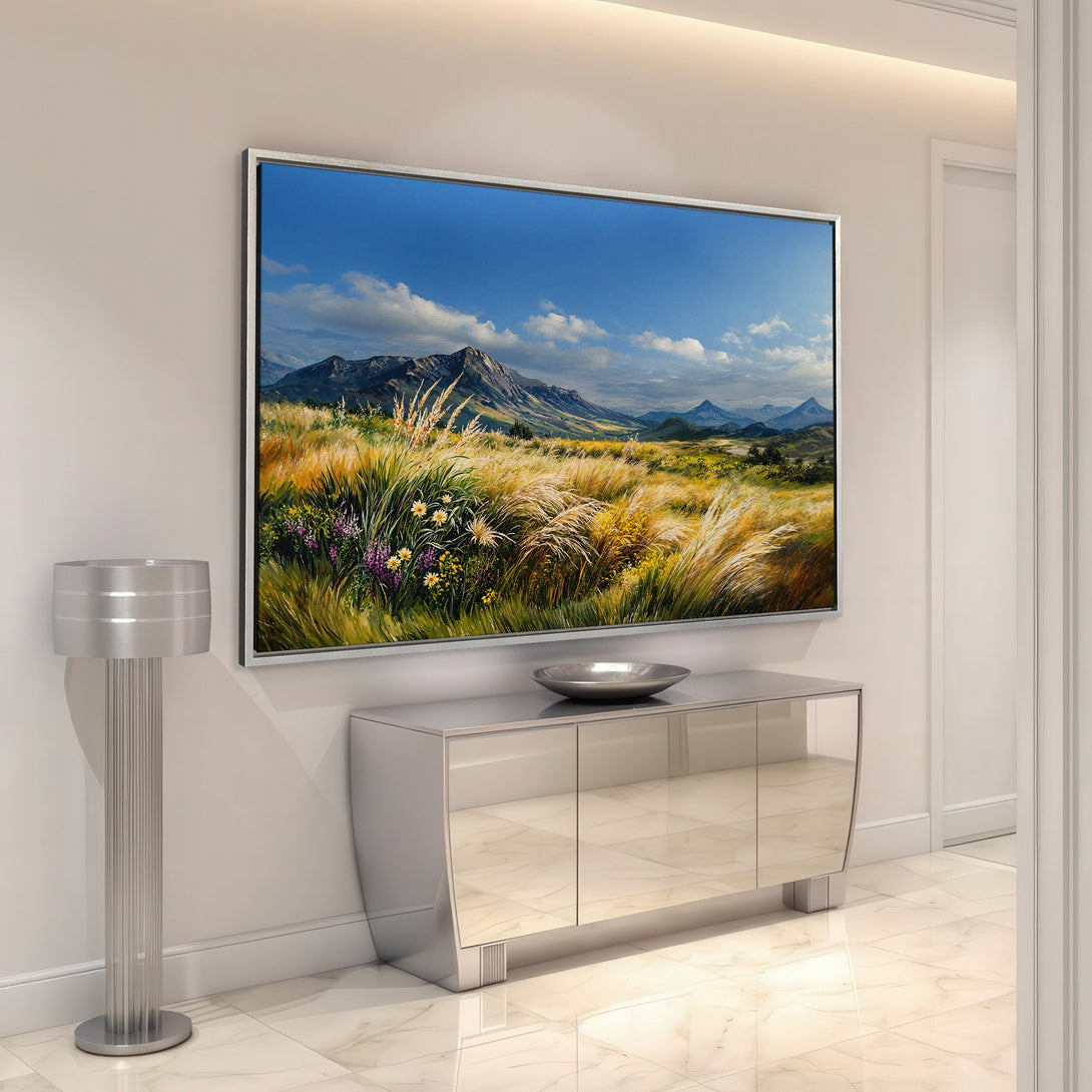 Framed Wall Art: Landscape Canvas Print in a modern interior. Features a mountain scene with blue skies, warm golden hues, and vibrant wildflowers. Perfect home decor!
